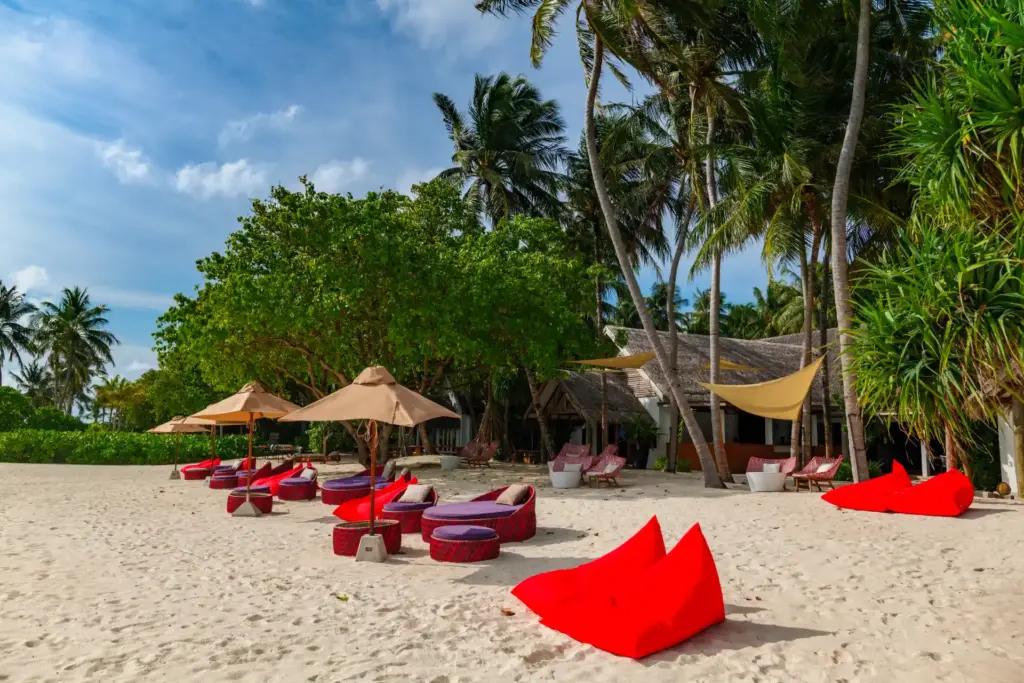 Rote Sitzsäcke am puderweißen Strand - im Baa Atoll auf den Malediven verwöhnen luxuriöse Villen in atemberaubendem Setting, abgerundet von einem Bouquet an abwechslungsreichen Aktivitäten. Katharina Fenners kennt die exklusivsten Hotels auf den Trauminseln im Indischen Ozean und berät Sie individuell!