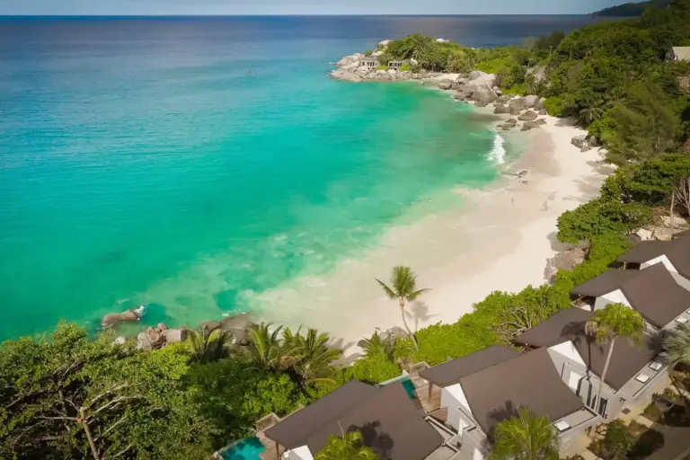 Der ruhige Strand vor dem intimen CaranaBeach Hotel ist auf beiden Seiten durch ikonische Felsen begrenzt und bietet somit besonders viel Privatsphäre - ein Geheimtipp für Ihre Seychellen-Auszeit zu zweit oder Ihre Seychellen-Hochzeitsreise! Buchbar bei Fenners Reisen.