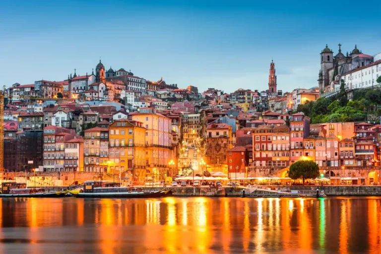 Die bunten Häuser Portos am Douro Fluss im Abendlicht - die Stadt ist berühmt für Portwein und eine lebhafte Kunstszene und ein mögliches Highlight Ihres Portugal Luxusurlaubs, individuell geplant von der Expertin Katharina Fenners.